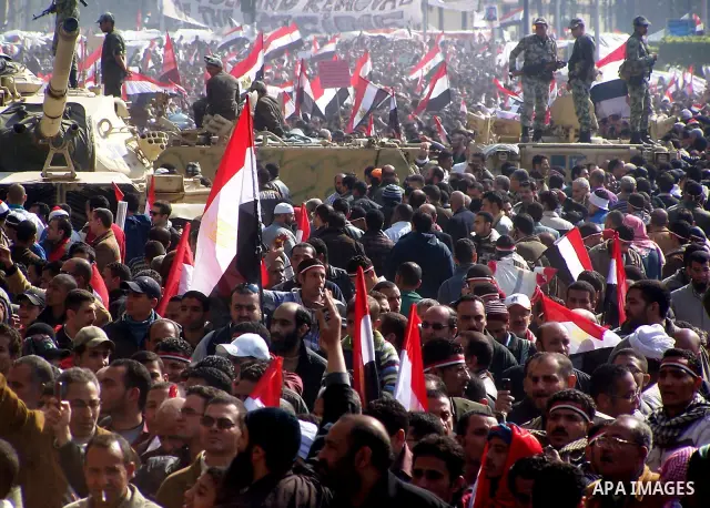 Anti-government protesters gather in front the state television building in Cairo, Egypt, Friday, Feb. 11, 2011. Mubarak has refused to step down or leave the country, and instead handed his administrative powers to his...