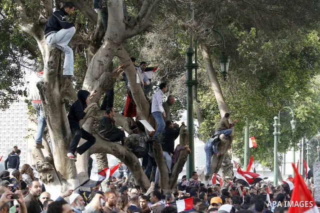 Anti-government protesters gather in front the state television building in Cairo, Egypt, Friday, Feb. 11, 2011. Mubarak has refused to step down or leave the country, and instead handed his administrative powers to his...