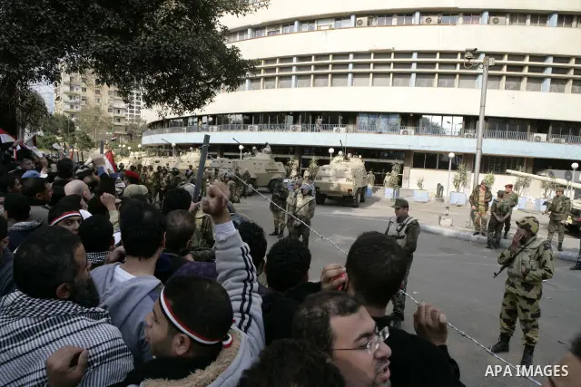 Anti-government protesters gather in front the state television building in Cairo, Egypt, Friday, Feb. 11, 2011. Mubarak has refused to step down or leave the country, and instead handed his administrative powers to his...