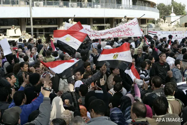 Anti-government protesters gather in front the state television building in Cairo, Egypt, Friday, Feb. 11, 2011. Mubarak has refused to step down or leave the country, and instead handed his administrative powers to his...