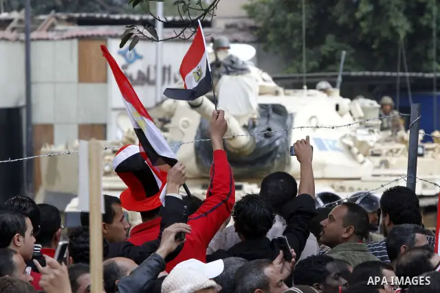 Anti-government protesters gather in front the state television building in Cairo, Egypt, Friday, Feb. 11, 2011. Mubarak has refused to step down or leave the country, and instead handed his administrative powers to his...