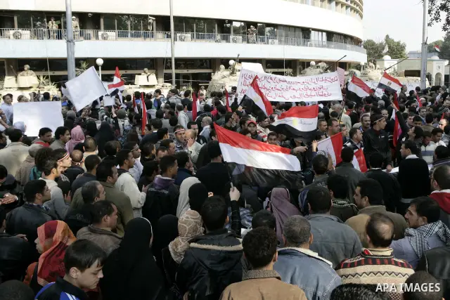 Anti-government protesters gather in front the state television building in Cairo, Egypt, Friday, Feb. 11, 2011. Mubarak has refused to step down or leave the country, and instead handed his administrative powers to his...
