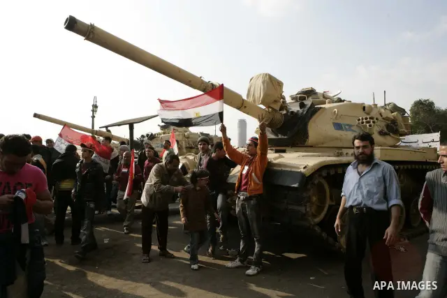 Anti-government protesters gather in front the state television building in Cairo, Egypt, Friday, Feb. 11, 2011. Mubarak has refused to step down or leave the country, and instead handed his administrative powers to his...