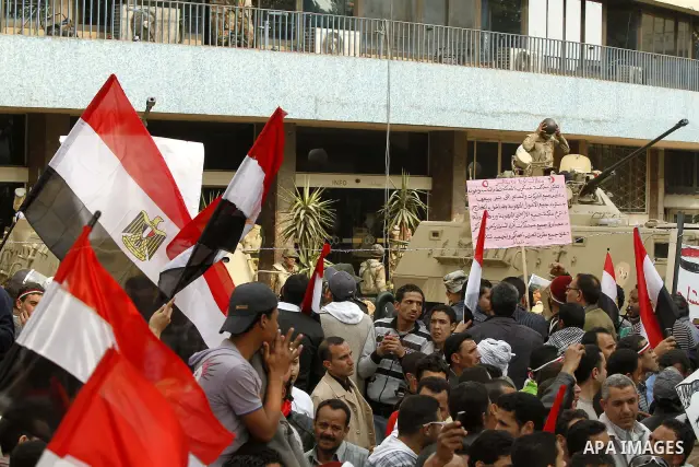 Anti-government protesters gather in front the state television building in Cairo, Egypt, Friday, Feb. 11, 2011. Mubarak has refused to step down or leave the country, and instead handed his administrative powers to his...
