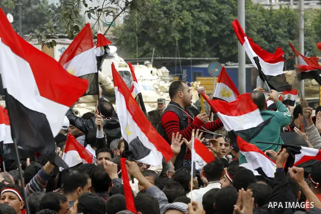 Anti-government protesters gather in front the state television building in Cairo, Egypt, Friday, Feb. 11, 2011. Mubarak has refused to step down or leave the country, and instead handed his administrative powers to his...
