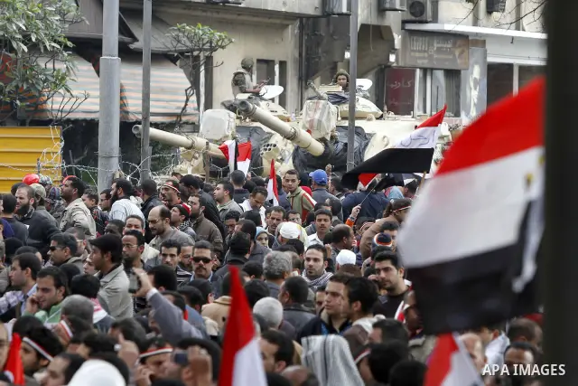 Anti-government protesters gather in front the state television building in Cairo, Egypt, Friday, Feb. 11, 2011. Mubarak has refused to step down or leave the country, and instead handed his administrative powers to his...