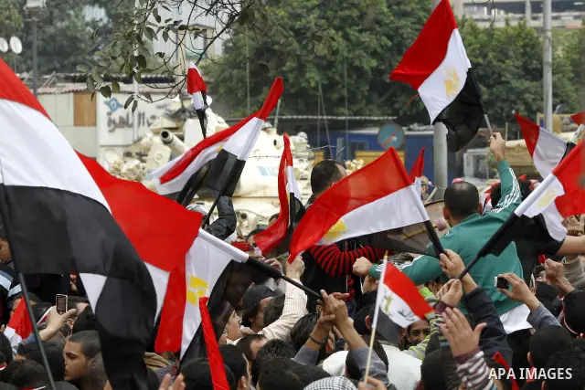 Anti-government protesters gather in front the state television building in Cairo, Egypt, Friday, Feb. 11, 2011. Mubarak has refused to step down or leave the country, and instead handed his administrative powers to his...