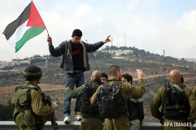 Israeli soldiers restrain Palestinian ,Israeli and foreign protesters during a protest against Israel's controversial separation barrier in the West Bank village of Massarah,near the biblical town of Bethlehem, on Februa...