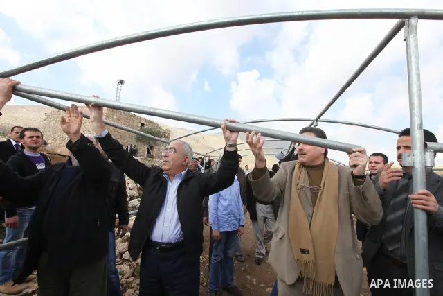 Palestinian Prime Minister Salam Fayyad visits the houses which were destroyed by Israeli army in the village of Khirbet Tana near the West Bank city of Nablus, Feb. 11, 2011. Photo by Mustafa Abu Dayeh