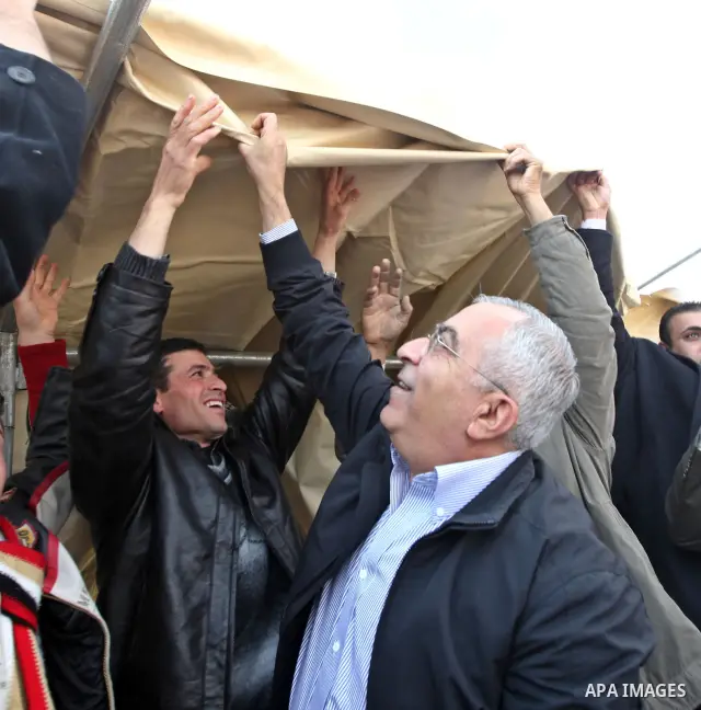 Palestinian Prime Minister Salam Fayyad visits the houses which were destroyed by Israeli army in the village of Khirbet Tana near the West Bank city of Nablus, Feb. 11, 2011. Photo by Mustafa Abu Dayeh