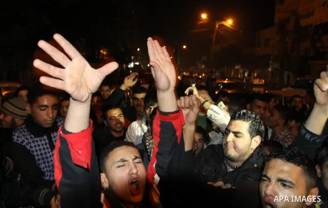 Palestinians celebrate the news of the resignation of President Hosni Mubarak, who handed control of the country to the military, at night in Gaza city, Friday, Feb. 11, 2011 Photo by Naaman Omar