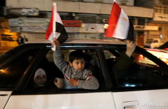 Palestinians celebrate the news of the resignation of President Hosni Mubarak, who handed control of the country to the military, at night in Gaza city, Friday, Feb. 11, 2011 Photo by Naaman Omar