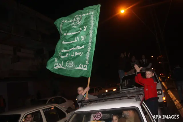 Palestinians celebrate the news of the resignation of President Hosni Mubarak, who handed control of the country to the military, at night in Gaza city, Friday, Feb. 11, 2011 Photo by Mohamed Asad