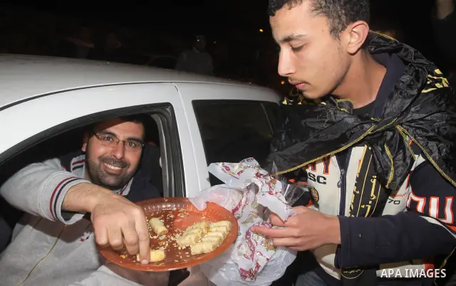 Palestinians celebrate the news of the resignation of President Hosni Mubarak, who handed control of the country to the military, at night in Gaza city, Friday, Feb. 11, 2011 Photo by Mohamed Asad