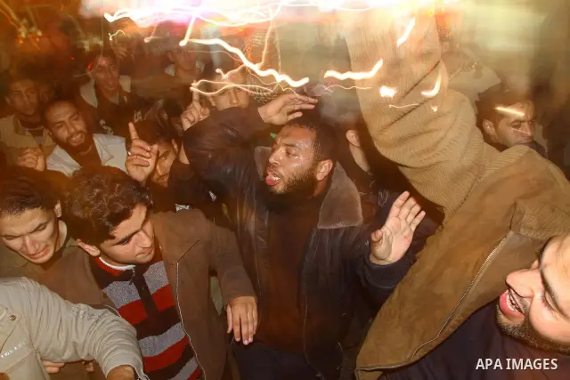 Palestinian Hamas supporters celebrate the news of the resignation of President Hosni Mubarak, who handed control of the country to the military, at night in Deir al-Balah in the central Gaza Strip, Friday, Feb. 11, 2011...