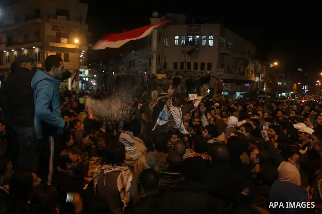Palestinians celebrate the news of the resignation of President Hosni Mubarak, who handed control of the country to the military, at night in the West Bank city of Ramallah, Friday, Feb. 11, 2011. Photo by Issam Rimawi