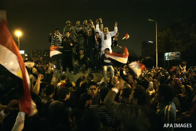 Egyptians celebrate the news of the resignation of President Hosni Mubarak, who handed control of the country to the military, at night in Tahrir Square in downtown Cairo, Egypt Friday, Feb. 11, 2011. Photo by Karam Nass...