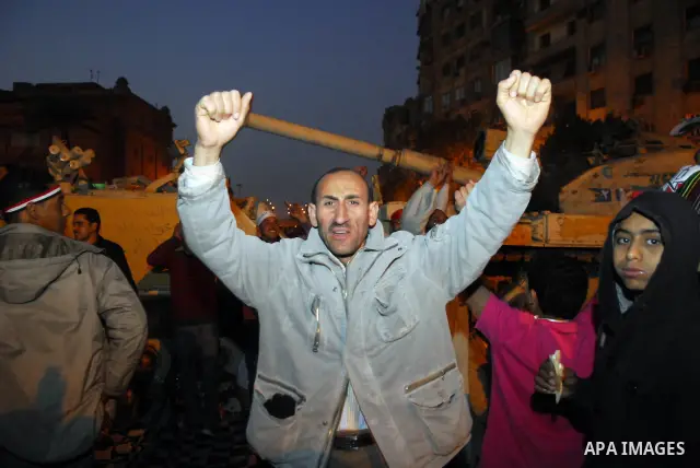 Egyptians celebrate the news of the resignation of President Hosni Mubarak, who handed control of the country to the military, at night in Tahrir Square in downtown Cairo, Egypt Friday, Feb. 11, 2011. Photo by Ahmed Asad