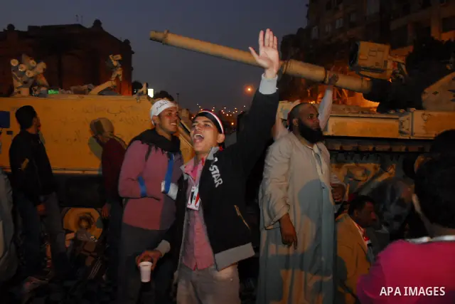 Egyptians celebrate the news of the resignation of President Hosni Mubarak, who handed control of the country to the military, at night in Tahrir Square in downtown Cairo, Egypt Friday, Feb. 11, 2011. Photo by Ahmed Asad