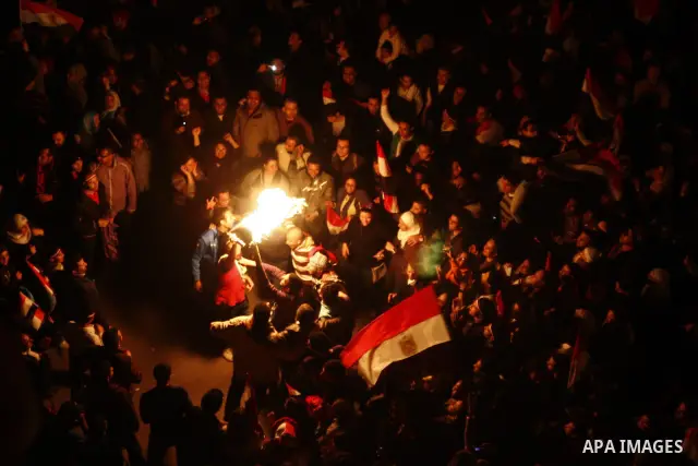 Egyptians celebrate the news of the resignation of President Hosni Mubarak, who handed control of the country to the military, at night in Tahrir Square in downtown Cairo, Egypt Friday, Feb. 11, 2011. Photo by Ahmed Asad