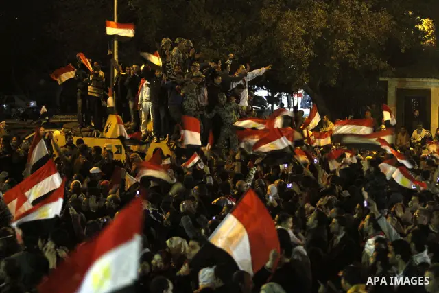 Egyptians celebrate the news of the resignation of President Hosni Mubarak, who handed control of the country to the military, at night in Tahrir Square in downtown Cairo, Egypt Friday, Feb. 11, 2011. Photo by Karam Nass...