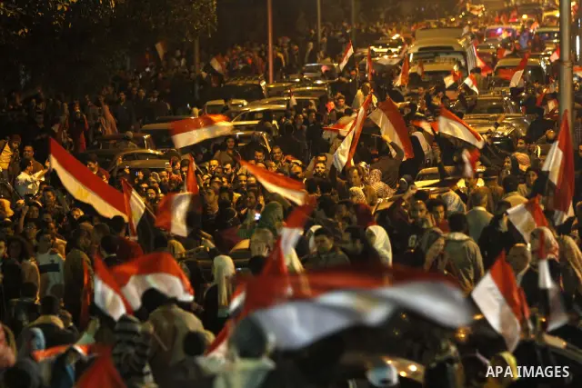 Egyptians celebrate the news of the resignation of President Hosni Mubarak, who handed control of the country to the military, at night in Tahrir Square in downtown Cairo, Egypt Friday, Feb. 11, 2011. Photo by Karam Nass...