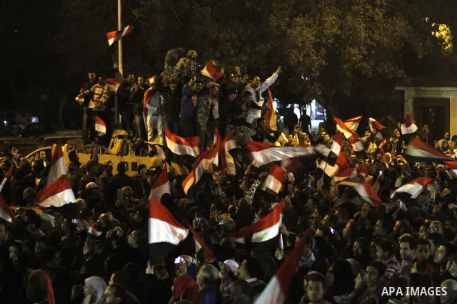 Egyptians celebrate the news of the resignation of President Hosni Mubarak, who handed control of the country to the military, at night in Tahrir Square in downtown Cairo, Egypt Friday, Feb. 11, 2011. Photo by Karam Nass...