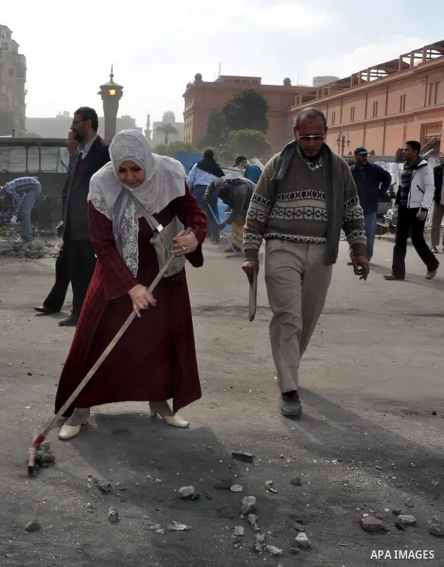 Egyptians clean up garbage and rocks from a street near Tahrir Square in downtown Cairo, Egypt, Saturday, Feb. 12, 2011. Egyptian protesters were jubilant Saturday over their success in ousting former President Hosni Mub...