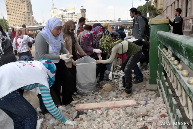 Egyptians clean up garbage and rocks from a street near Tahrir Square in downtown Cairo, Egypt, Saturday, Feb. 12, 2011. Egyptian protesters were jubilant Saturday over their success in ousting former President Hosni Mub...