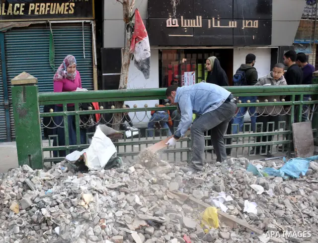 Egyptians clean up garbage and rocks from a street near Tahrir Square in downtown Cairo, Egypt, Saturday, Feb. 12, 2011. Egyptian protesters were jubilant Saturday over their success in ousting former President Hosni Mub...