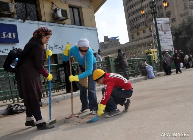 Egyptians clean up garbage and rocks from a street near Tahrir Square in downtown Cairo, Egypt, Saturday, Feb. 12, 2011. Egyptian protesters were jubilant Saturday over their success in ousting former President Hosni Mub...