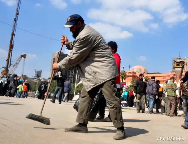 Egyptians clean up garbage and rocks from a street near Tahrir Square in downtown Cairo, Egypt, Saturday, Feb. 12, 2011. Egyptian protesters were jubilant Saturday over their success in ousting former President Hosni Mub...