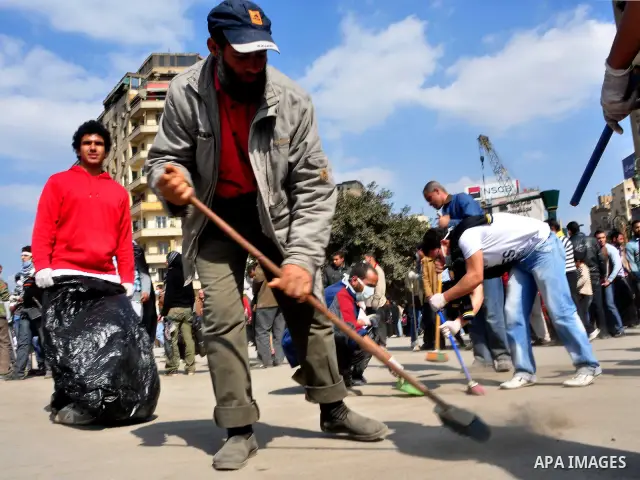 Egyptians clean up garbage and rocks from a street near Tahrir Square in downtown Cairo, Egypt, Saturday, Feb. 12, 2011. Egyptian protesters were jubilant Saturday over their success in ousting former President Hosni Mub...