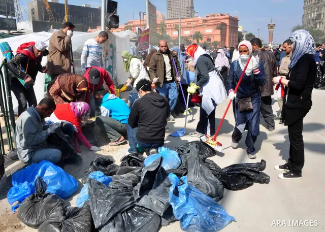 Egyptians clean up garbage and rocks from a street near Tahrir Square in downtown Cairo, Egypt, Saturday, Feb. 12, 2011. Egyptian protesters were jubilant Saturday over their success in ousting former President Hosni Mub...