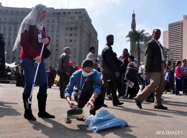Egyptians clean up garbage and rocks from a street near Tahrir Square in downtown Cairo, Egypt, Saturday, Feb. 12, 2011. Egyptian protesters were jubilant Saturday over their success in ousting former President Hosni Mub...