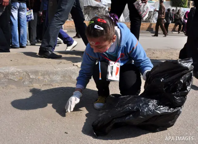 Egyptians clean up garbage and rocks from a street near Tahrir Square in downtown Cairo, Egypt, Saturday, Feb. 12, 2011. Egyptian protesters were jubilant Saturday over their success in ousting former President Hosni Mub...
