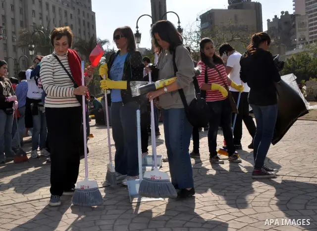 Egyptians clean up garbage and rocks from a street near Tahrir Square in downtown Cairo, Egypt, Saturday, Feb. 12, 2011. Egyptian protesters were jubilant Saturday over their success in ousting former President Hosni Mub...