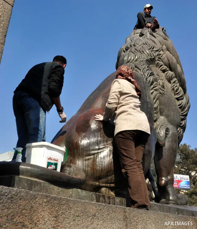 Egyptians clean up garbage and rocks from a street near Tahrir Square in downtown Cairo, Egypt, Saturday, Feb. 12, 2011. Egyptian protesters were jubilant Saturday over their success in ousting former President Hosni Mub...