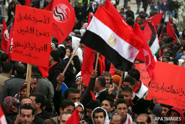 Palestinians wave an Egyptian flag and red flags during a demonstration marking the 29th anniversary of the Palestinian People's Party, a socialist political party, in the West Bank city of Ramallah, Saturday, Feb. 12, 2...