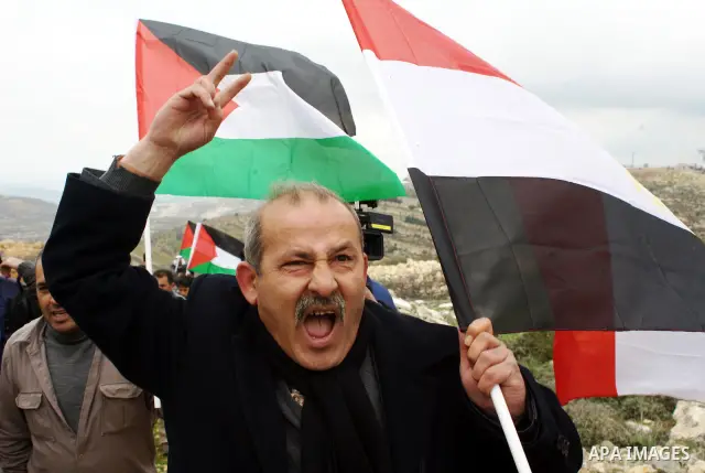 A Palestinian demonstrator argues with an Israeli soldier during a protest against Israel's controversial separation barrier organized by Palestinian and foreign peace activists in the West Bank village of Beit Omar, nea...