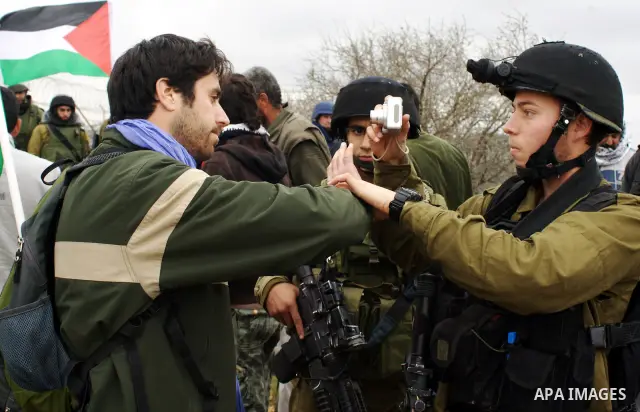 A Palestinian demonstrator argues with an Israeli soldier during a protest against Israel's controversial separation barrier organized by Palestinian and foreign peace activists in the West Bank village of Beit Omar, nea...