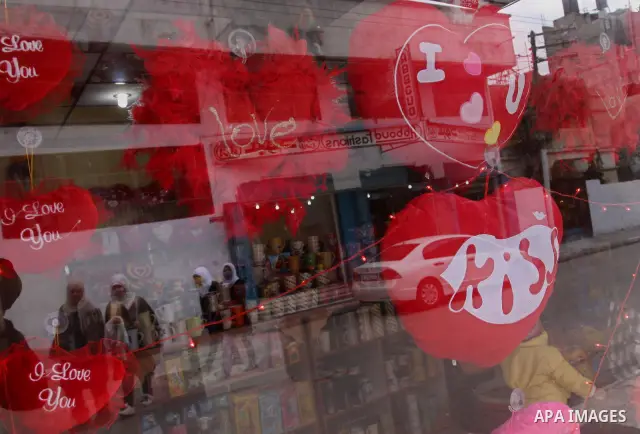 Palestinian girls are reflected in a glass window at a gift shop in Gaza City on Feb. 13, 2011. Valentine's Day marks a Christian holiday on Feb, 14. Photo by Mohammed Asad