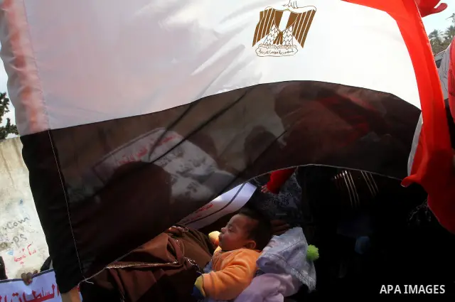 Palestinian supporters of Democratic Front for the Liberation of Palestine (DFLP) hold Egypt flag in support of the protesters in Egypt who forced their President Hosni Mubarak to resign, as they march in a rally in Gaza...