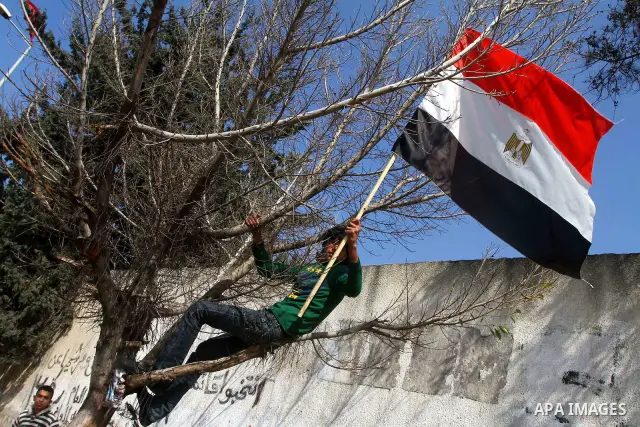Palestinian supporters of Democratic Front for the Liberation of Palestine (DFLP) hold Egypt flag in support of the protesters in Egypt who forced their President Hosni Mubarak to resign, as they march in a rally in Gaza...