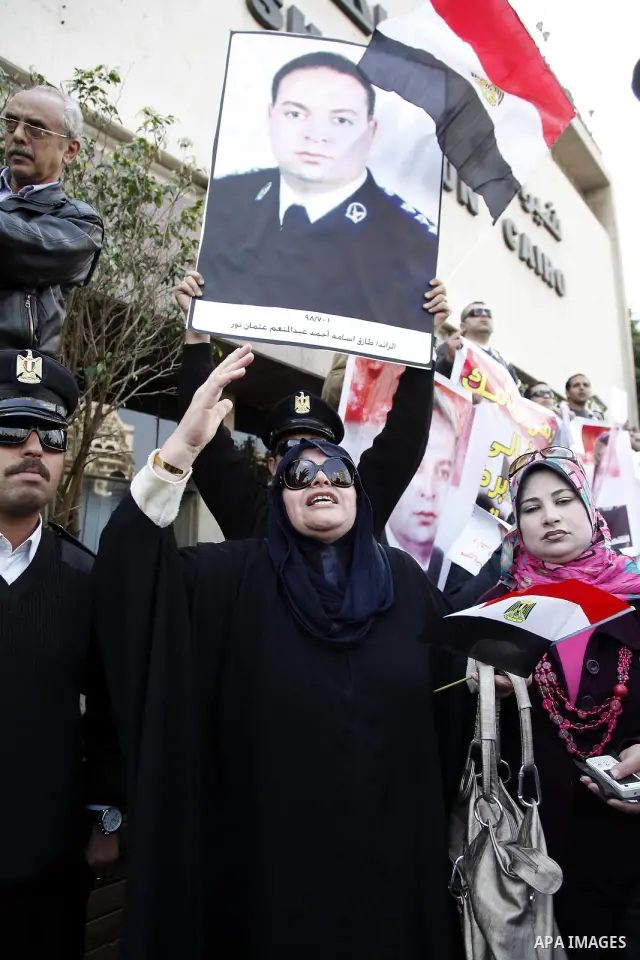 Egyptian police officers and protesters shout ''The police and the people are one hand', in Tahrir Square in downtown Cairo, Egypt Feb. 14, 2011. Egypt's military is taking down the makeshift tents of protesters who camp...