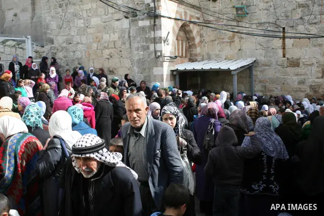 Palestinians go to Ibrahimi mosque as they march in a procession to mark the birth anniversary of Islam's prophet Mohammed, in the West Bank city of Hebron Tuesday, Feb. 15, 2011. Muslims celebrate Prophet Mohammed's bir...