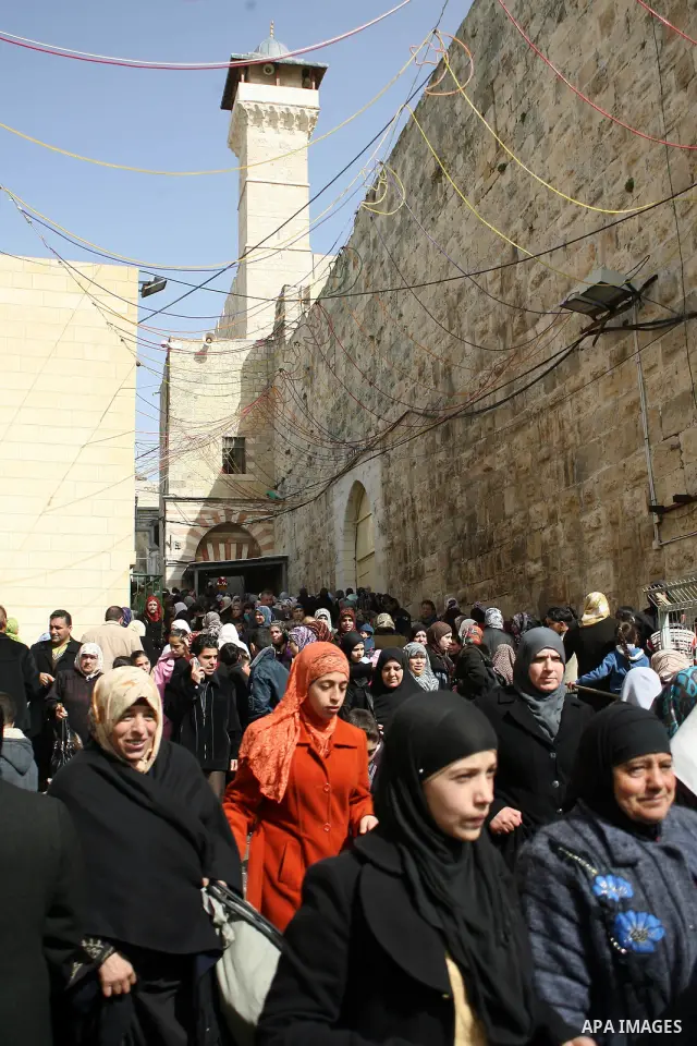 Palestinians go to Ibrahimi mosque as they march in a procession to mark the birth anniversary of Islam's prophet Mohammed, in the West Bank city of Hebron Tuesday, Feb. 15, 2011. Muslims celebrate Prophet Mohammed's bir...