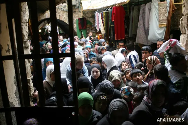 Palestinians go to Ibrahimi mosque as they march in a procession to mark the birth anniversary of Islam's prophet Mohammed, in the West Bank city of Hebron Tuesday, Feb. 15, 2011. Muslims celebrate Prophet Mohammed's bir...