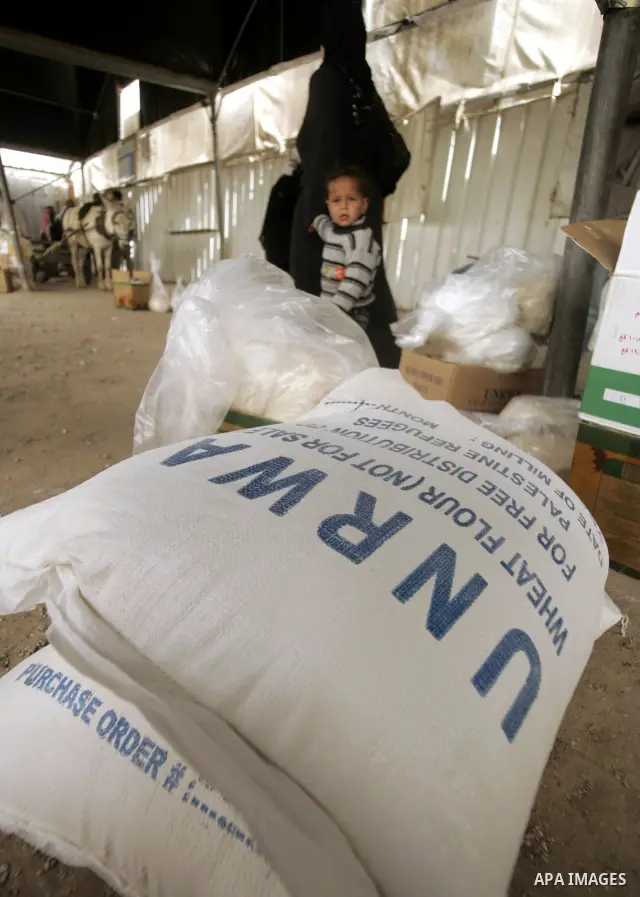 Palestinians receive food aids from the United Nations Relief and Works Agency (UNRWA) at the Rafah refugee camp, in the southern Gaza Strip on February 16, 2011. Accused the owners of destroyed houses and Relief and Wor...