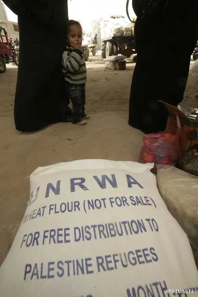 Palestinians receives food aids from the United Nations Relief and Works Agency (UNRWA) at the Rafah refugee camp, in the southern Gaza Strip on February 16, 2011. Accused the owners of destroyed houses that the Relief a...